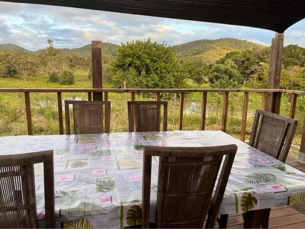 a table and chairs on a deck with a view at Bourail take rest in Bourail