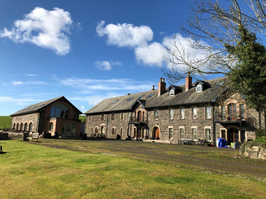 un gran edificio de piedra con techo negro en Riverside converted Linen Mill, en Coleraine