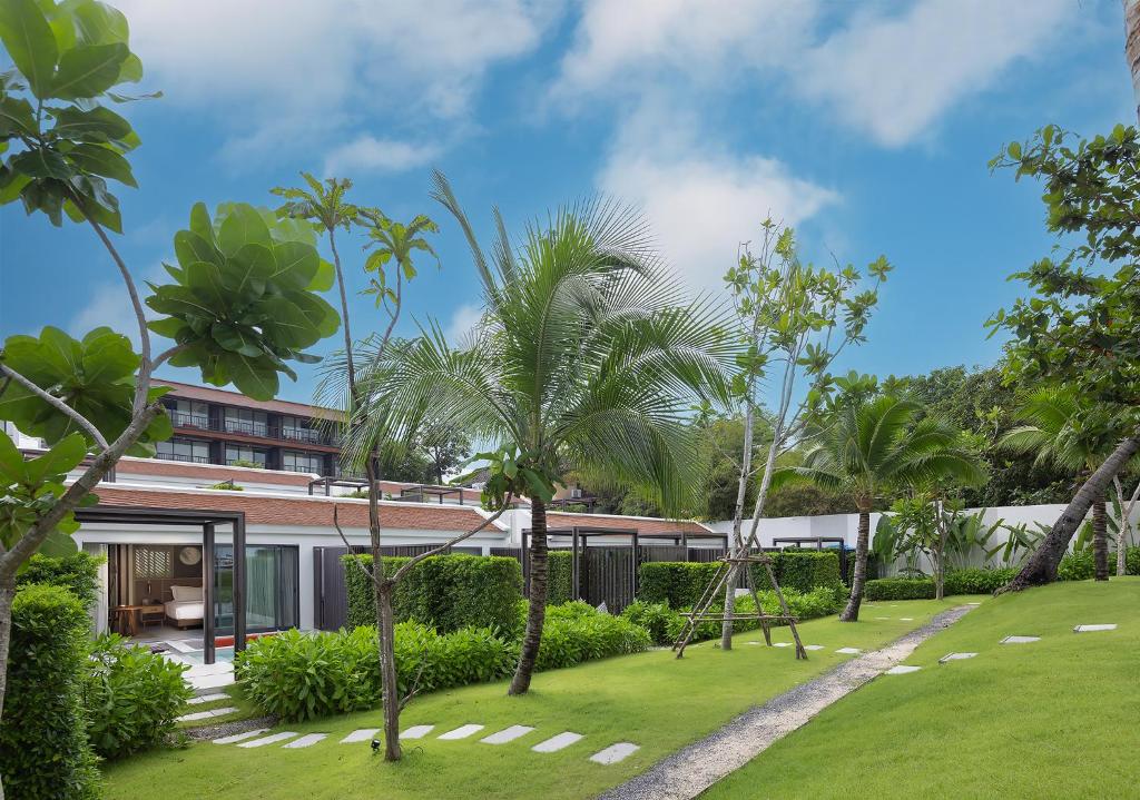 a resort with palm trees and a building at The Culture Samui in Bangrak Beach