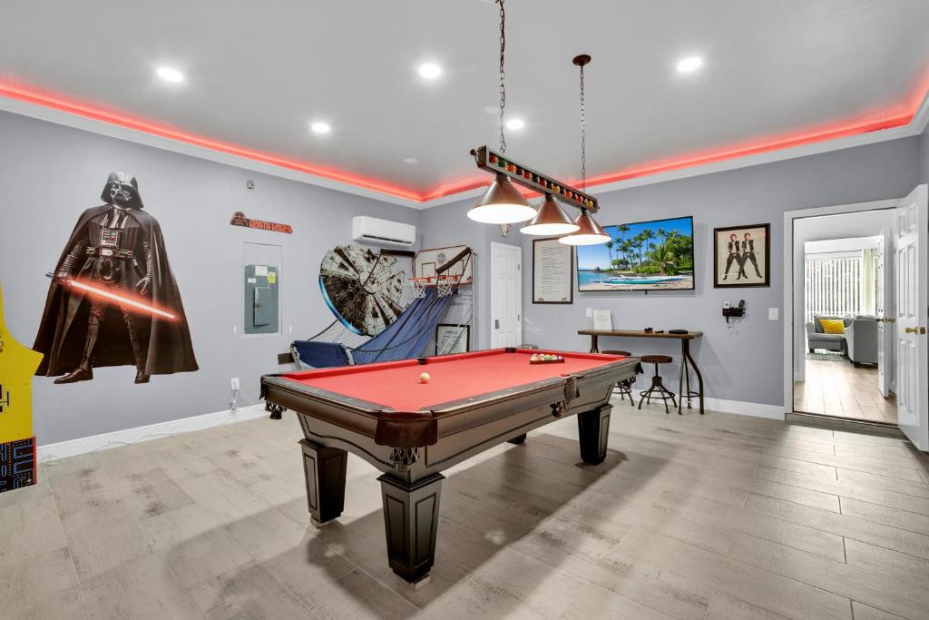 a room with a pool table and a spider man exhibit at Large 6BR Themed Family Villa Near Disney world in Kissimmee