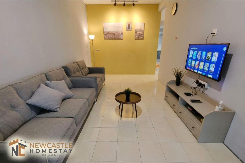 a living room with a couch and a flat screen tv at Newcastle Cozy Seri Impian Neflix Water Dispenser in Kluang