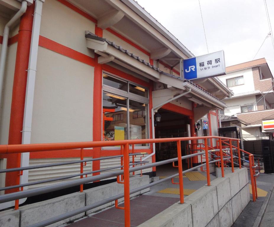 a gas station with an orange railing in front of it at One More Heart Fushimi Inari in Momoyama-chō