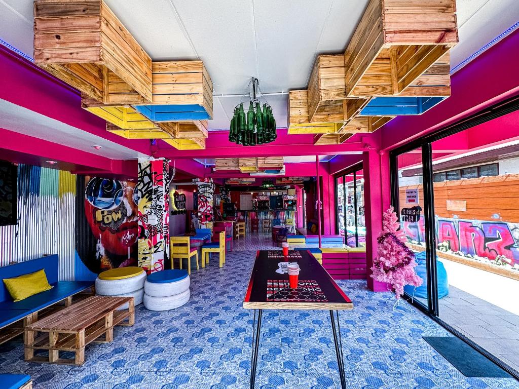 a room with a table and benches in a room at Slumber Party Chiang Mai in Chiang Mai