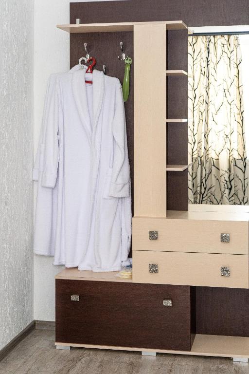 a closet with a white shirt and a dresser at Готель «На Кронштадській» in Avtozavodskiy Rayon