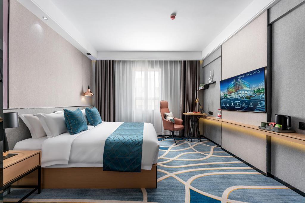 TV a/nebo společenská místnost v ubytování Jinshi Hotel