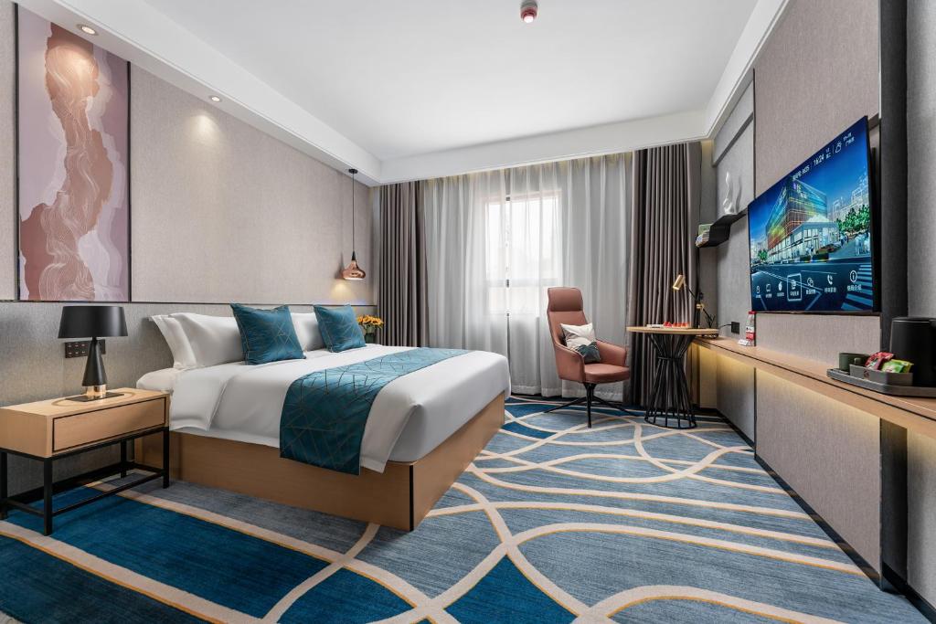 Postel nebo postele na pokoji v ubytování Jinshi Hotel