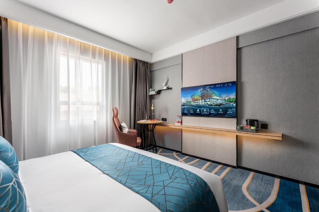 Postel nebo postele na pokoji v ubytování Jinshi Hotel