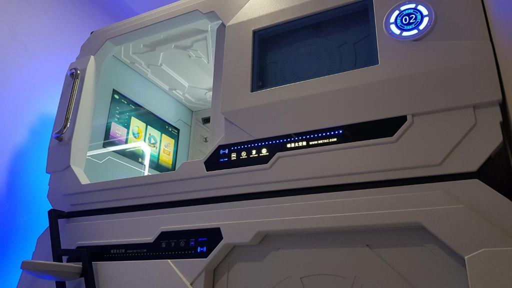 an inside of a video game arcade machine at Apollo Capsule Hotel in Ende