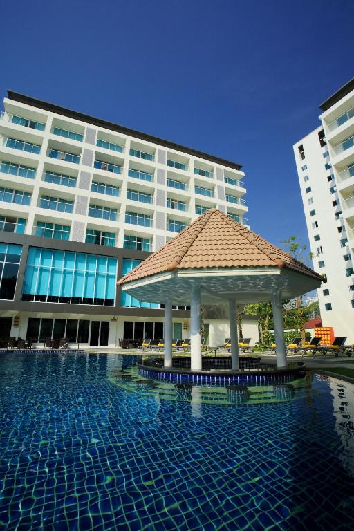 a swimming pool with a gazebo in front of a building at Centara Pattaya Hotel in Pattaya
