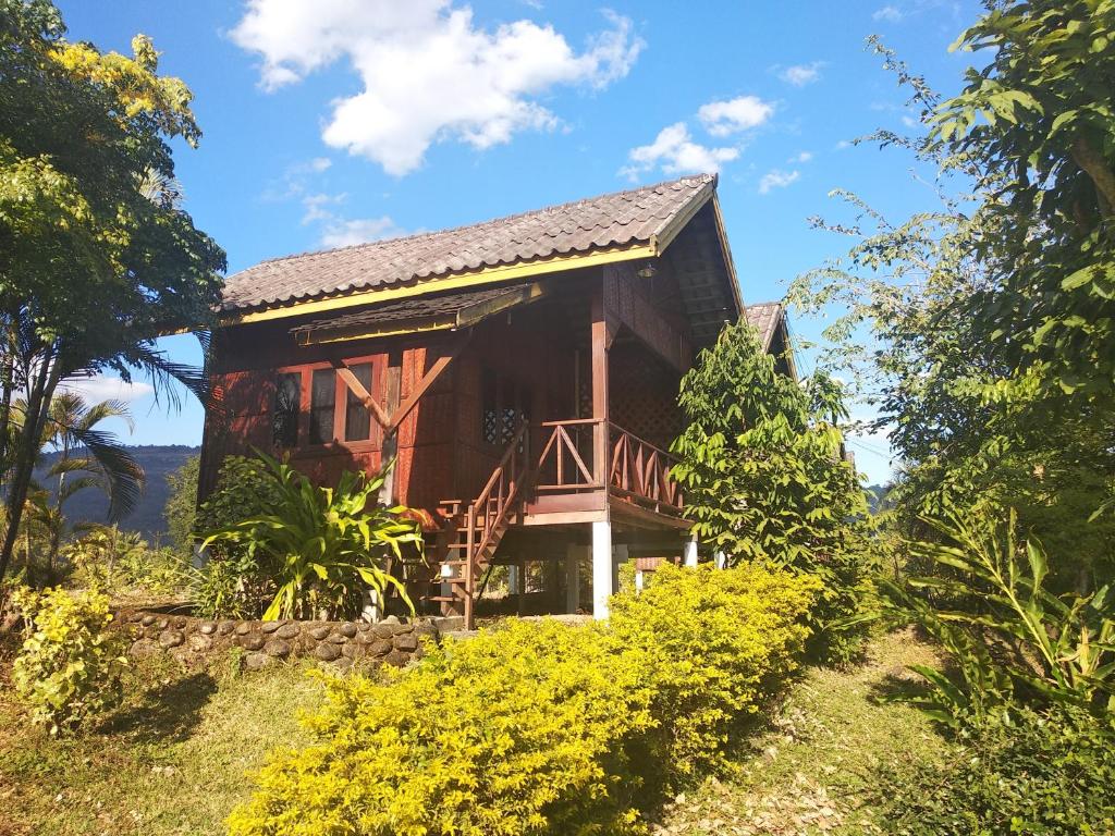 a house on a hill with trees and flowers at Sainamhai Resort in Ban Namsanam