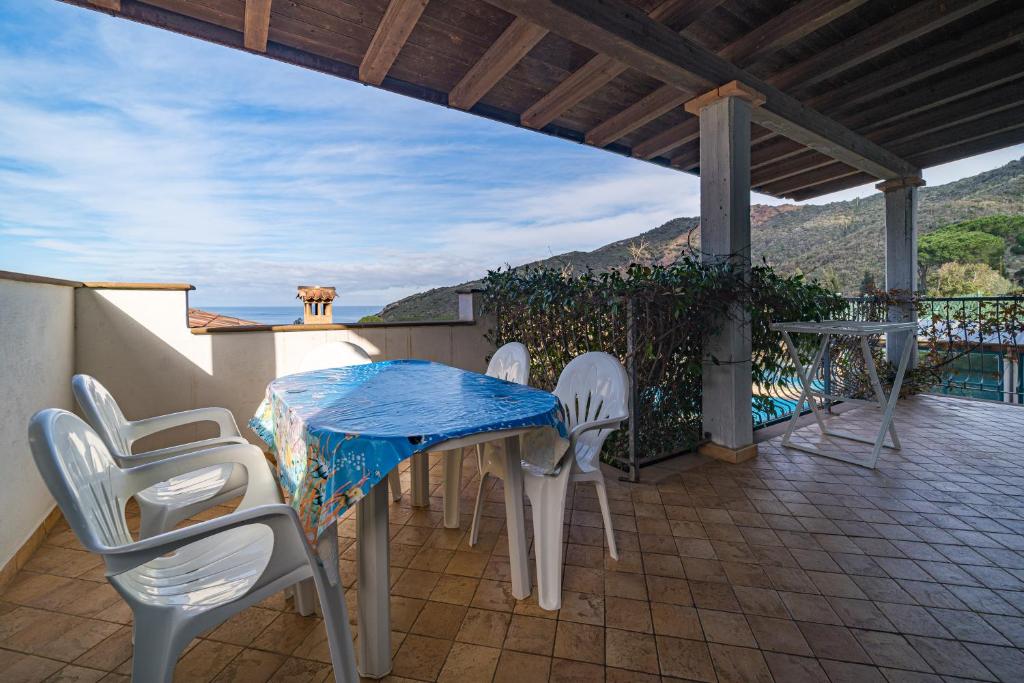 a table and chairs on a patio with a view at Appartamenti Nisportino in Nisporto