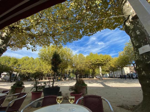 a table with glasses of wine sitting on a patio at La Peyreyre in Jaujac