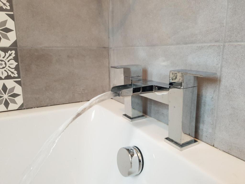 a bathroom sink with a water faucet at Redwood House in Liverpool