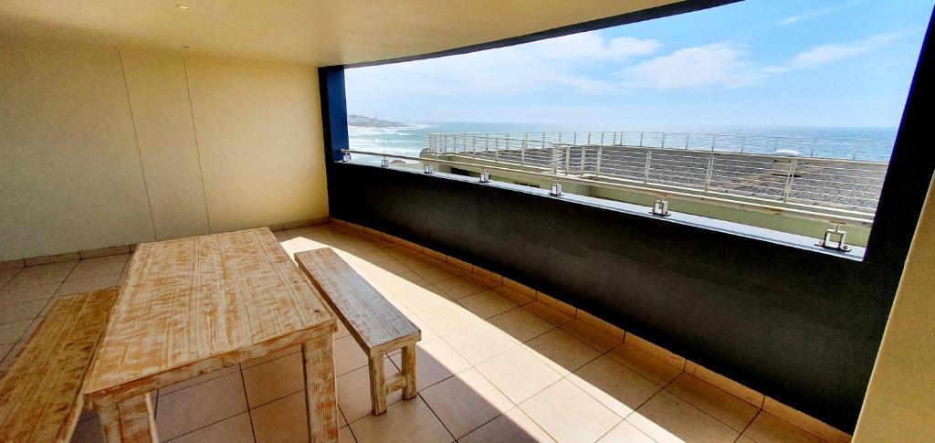 a large window in a room with a table and a balcony at La Mer 12 - 9 Sleeper - Stylish & Sophisticated! in Margate