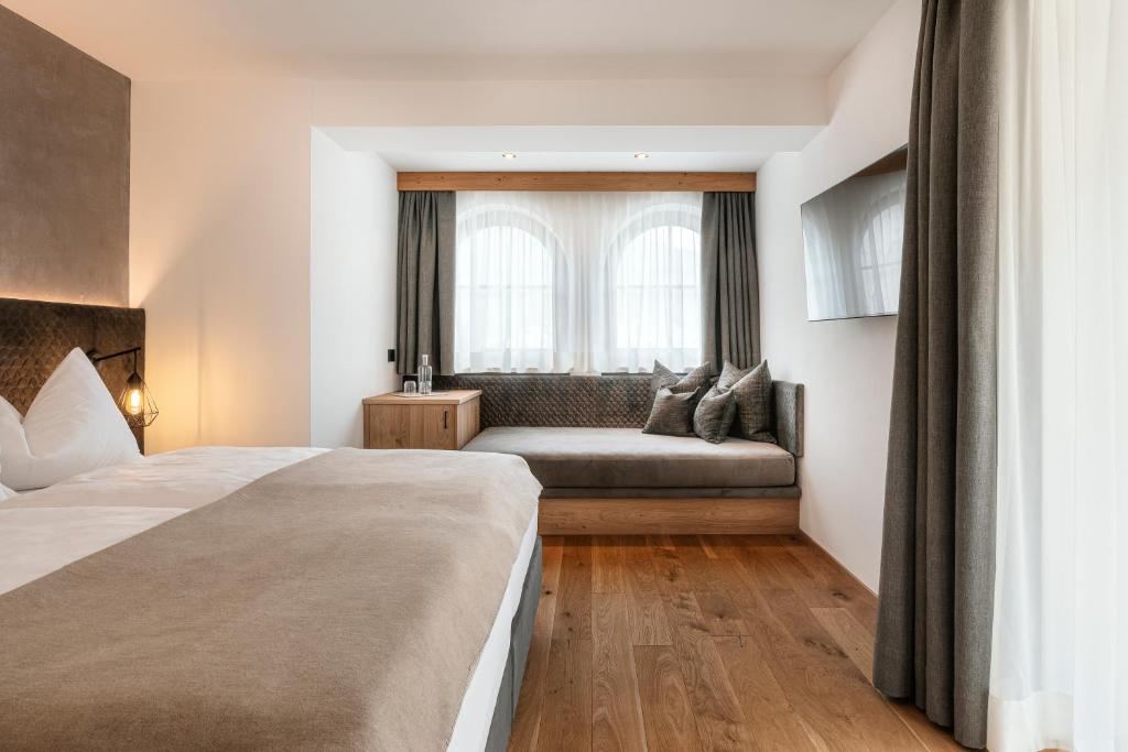 Postel nebo postele na pokoji v ubytování Hotel Niblea Dolomites