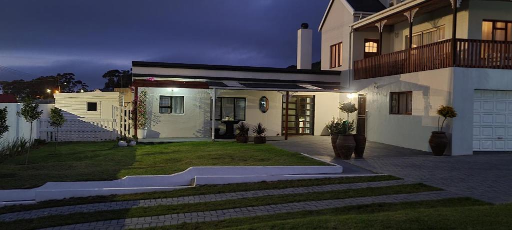 a large white house with a yard at night at 7 on South in Bredasdorp