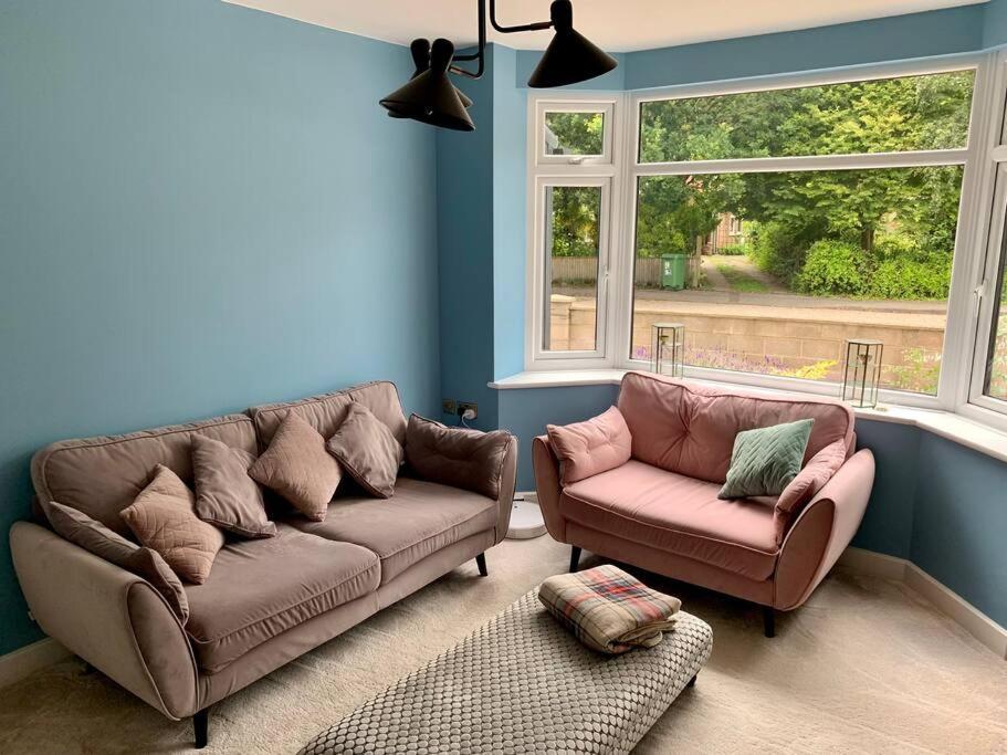 a living room with a couch and a chair at Modern 3 Bedroom Home in Coy Pond, Poole in Parkstone