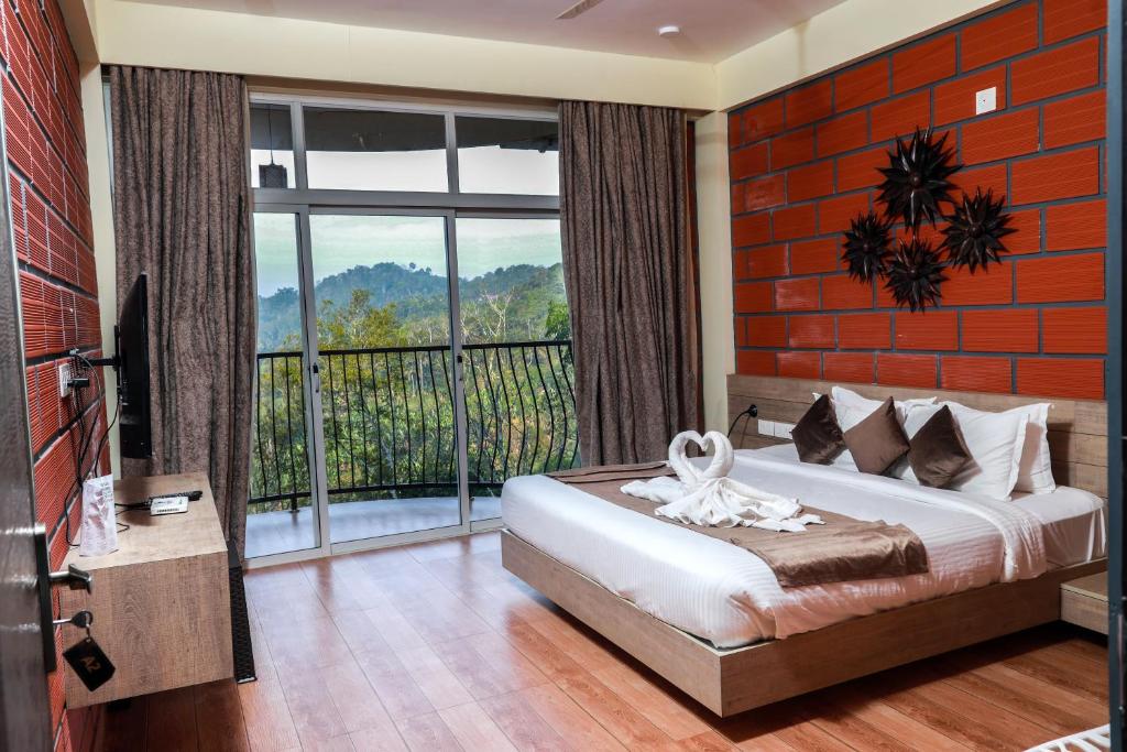 a bedroom with a bed and a large window at Serene Crest Resort in Mananthavady