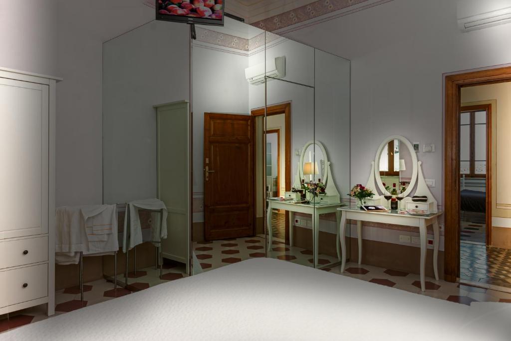 a bathroom with two sinks and two mirrors at Villino Ermione in Marina di Pisa