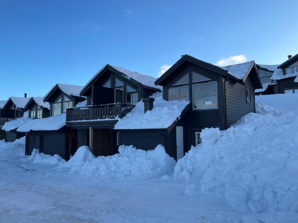 a group of houses are covered in snow at Fagertoppen 6B in Trysil