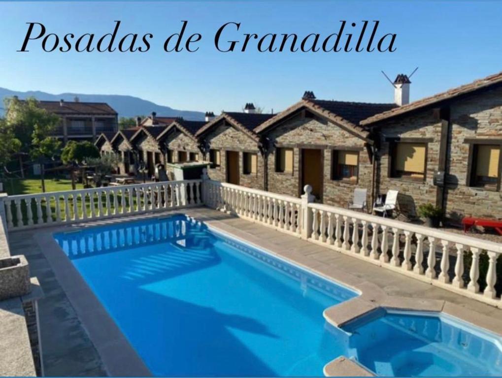 a swimming pool in front of a house at Posadas De Granadilla in Zarza de Granadilla