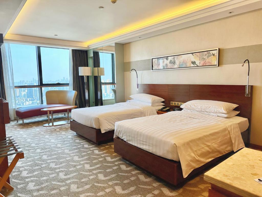 Postel nebo postele na pokoji v ubytování Swissotel Foshan, Guangdong - Free shuttle to Canton Fair