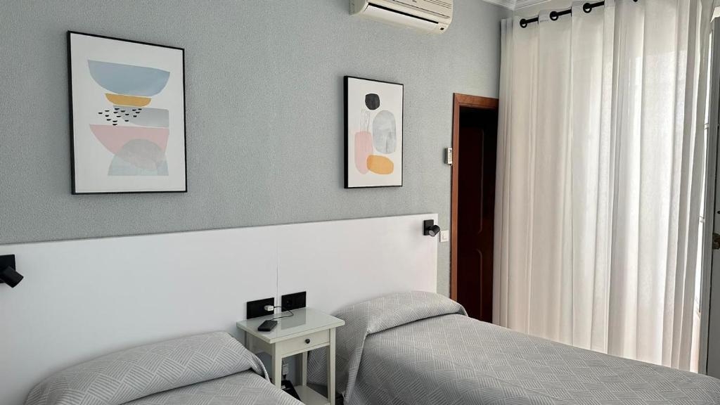 Postel nebo postele na pokoji v ubytování Hostal Bahía