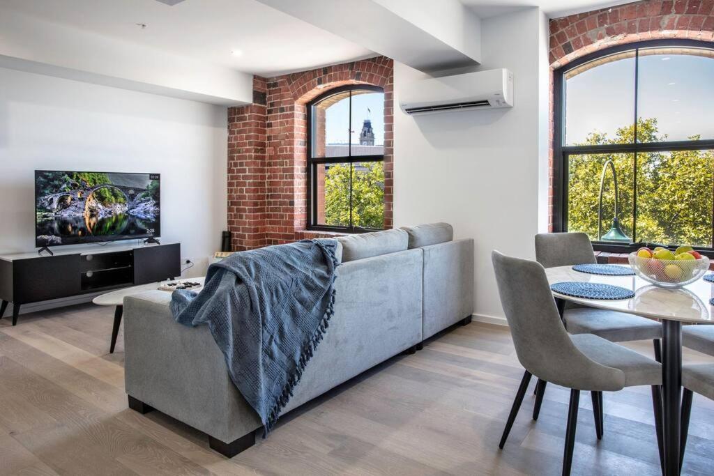 a living room with a couch and a table at Bendigo CBD Apartment in Bendigo