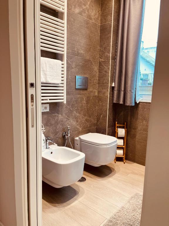 a bathroom with a white sink and a toilet at Urban Chic Home in Bari