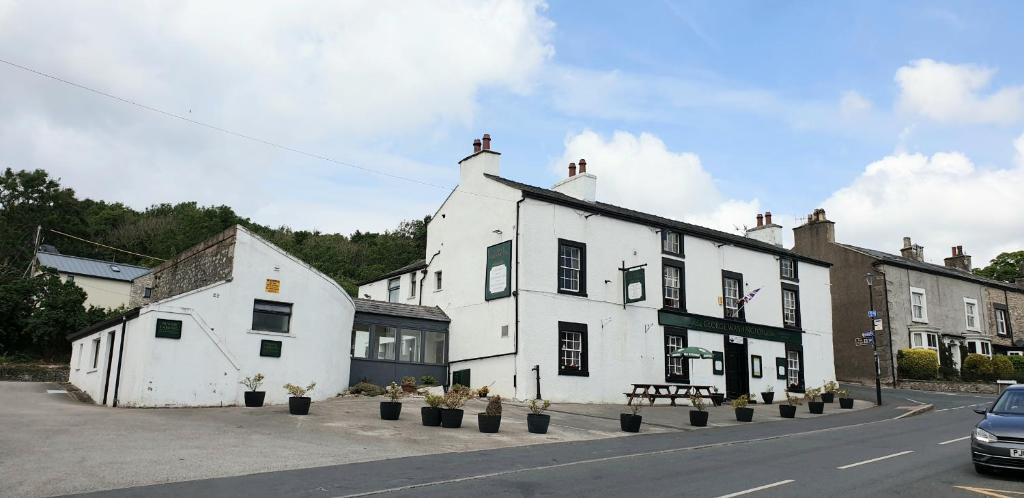 a white building on the side of a street at George Washington Inn in Carnforth