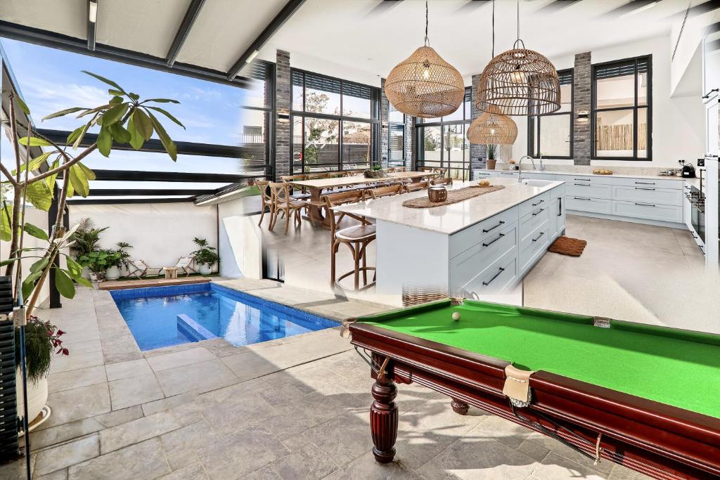 a pool table in a kitchen with a pool table at פרפקט וילה כרמית in Kramim