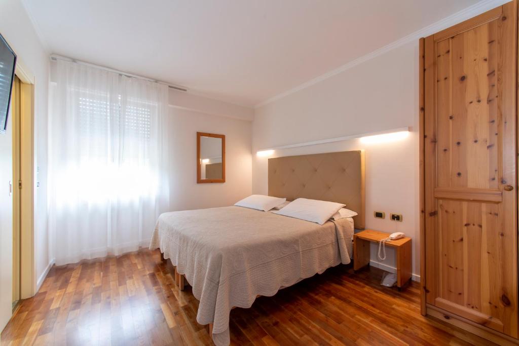 Postel nebo postele na pokoji v ubytování Hotel Lilla'