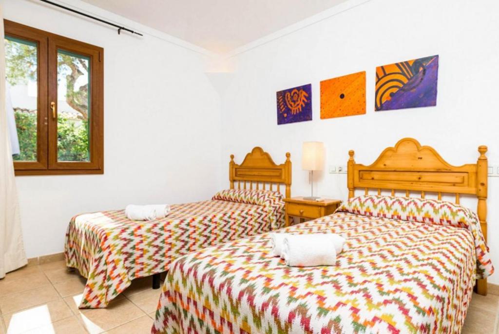 Postel nebo postele na pokoji v ubytování Villa Binimelis