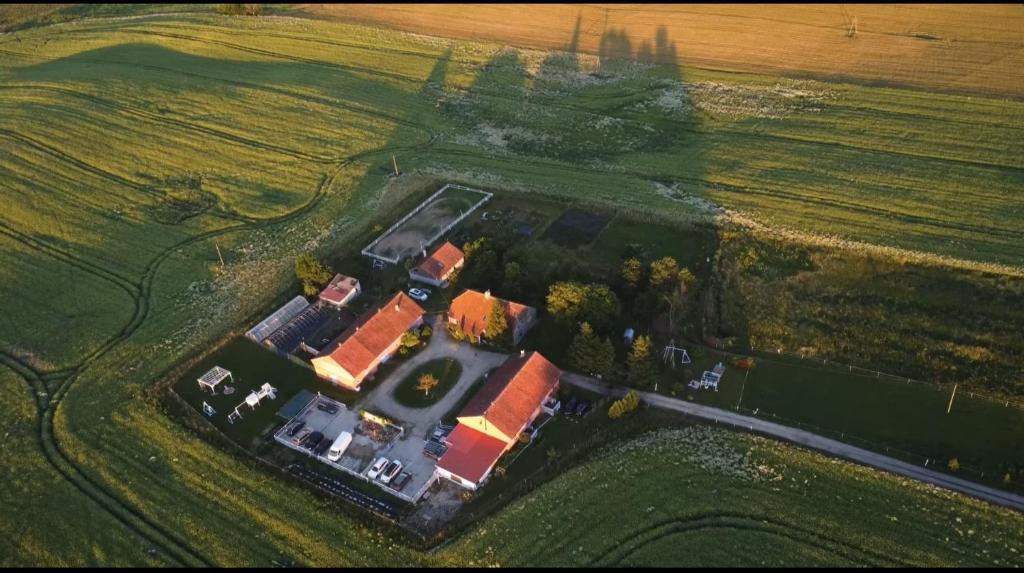 an aerial view of a house in a field at Folwark Malinowy Chruśniak in Bisztynek