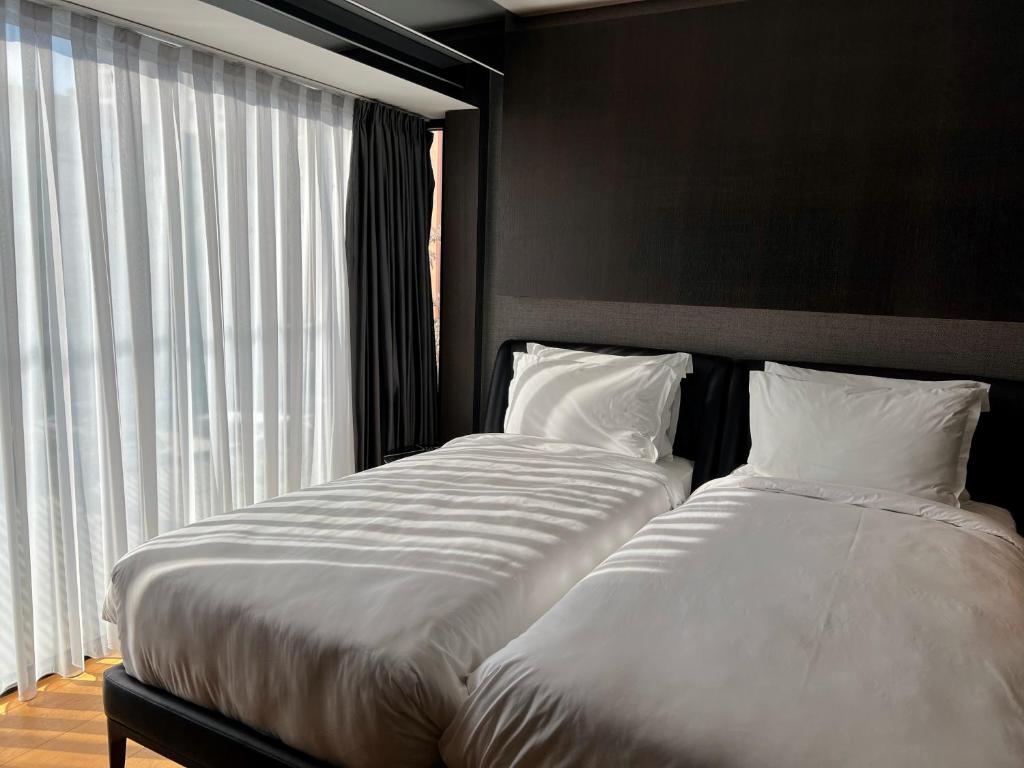 Postel nebo postele na pokoji v ubytování Hotel MANAMI
