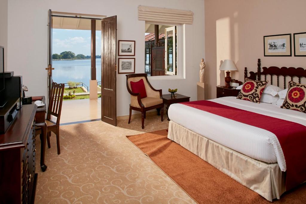 a hotel room with a bed and a television at EKHO Lake House in Polonnaruwa