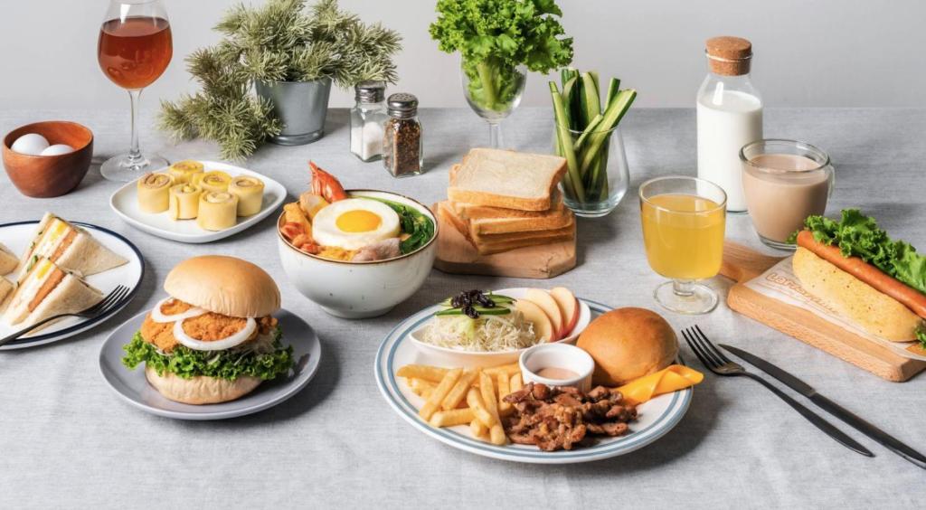 a table topped with plates of food and drinks at Edinburgh 16 Inn in Hengchun