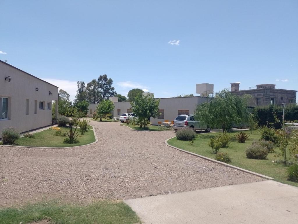 a driveway leading to a building with a parking lot at Cabañas 6 Olivos in San Rafael