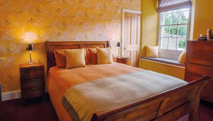 a bedroom with a large bed and a window at The Fox - West Witton in West Witton