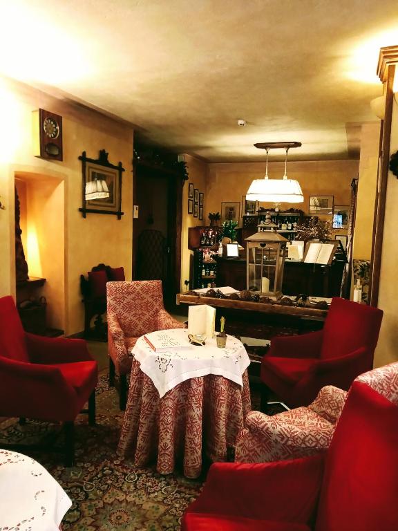 a restaurant with a table and chairs and a kitchen at Villa Novecento Romantic Hotel - Estella Hotel Collection & Experience in Courmayeur