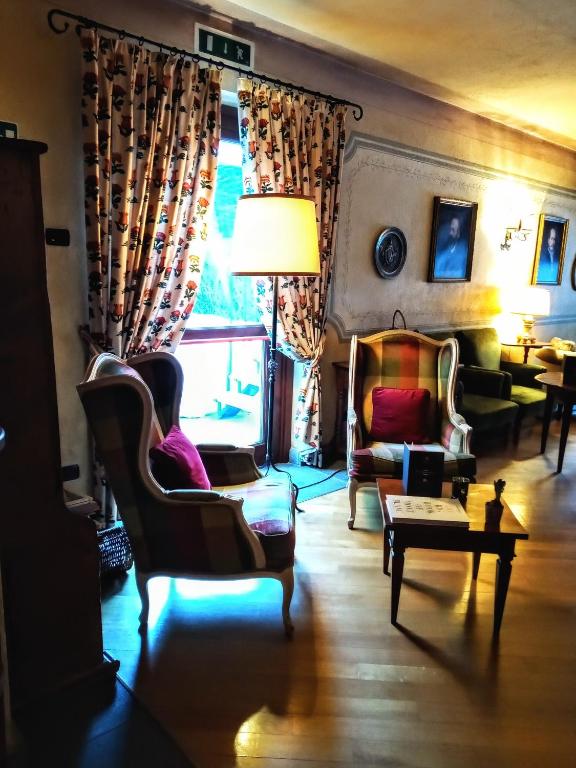 a living room with a couch and chairs and a window at Villa Novecento Romantic Hotel - Estella Hotel Collection & Experience in Courmayeur