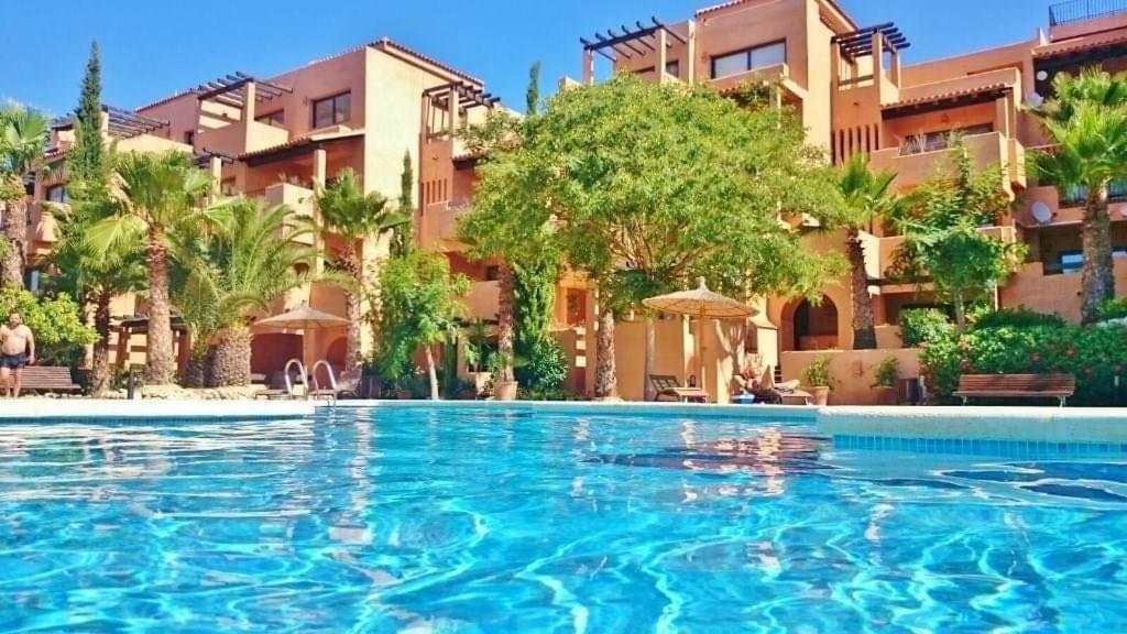 a large swimming pool in front of a building at Luxury large 2 bedroom Apartment short walk to Villamartin Plaza in Villamartin
