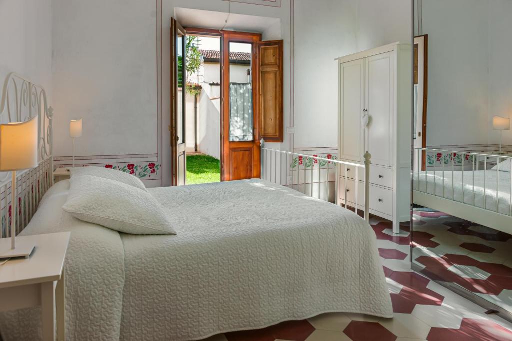 a bedroom with a large bed and a desk at Villino Ermione in Marina di Pisa