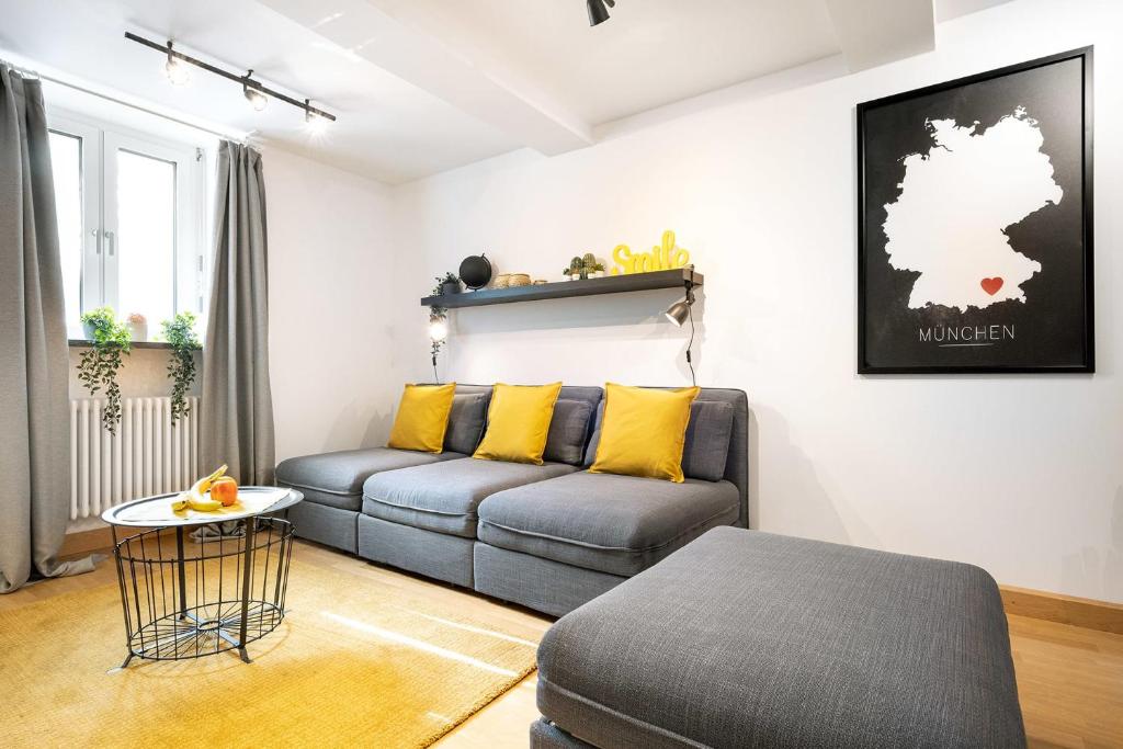 a living room with a couch and a table at MARIENPLATZ Apartment 2 bedrooms living room kitchen in Munich