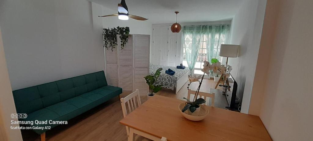 salon z zieloną kanapą i stołem w obiekcie Loft 105 w Corralejo