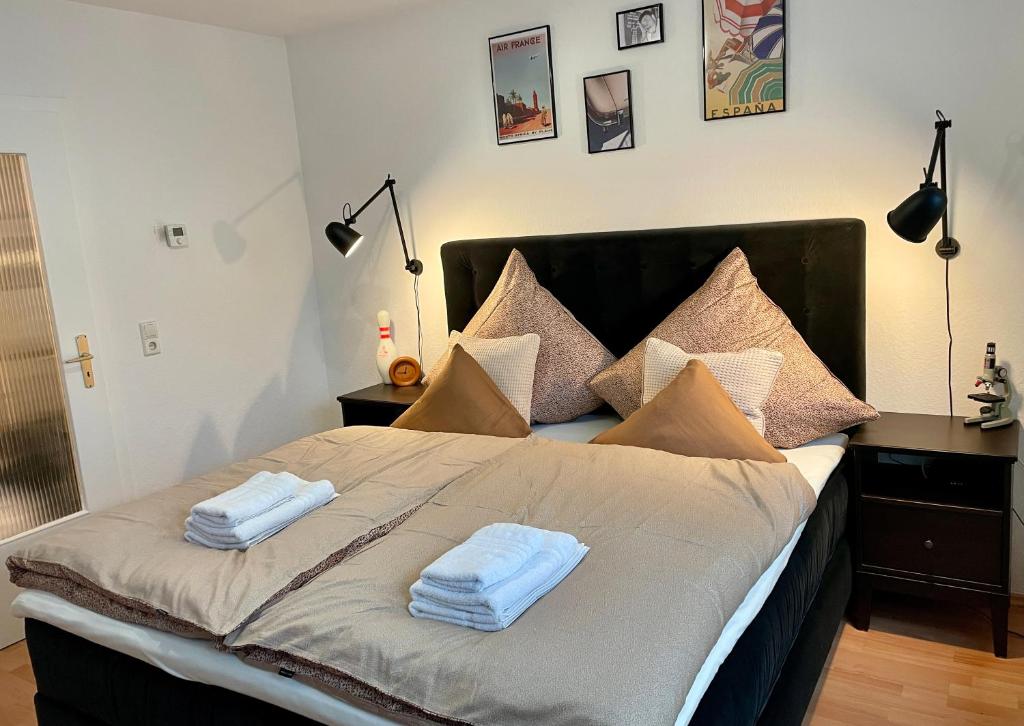 a bedroom with a bed with two towels on it at SPLENDiD: ☆Vintageflat In Center☆ in Hannover