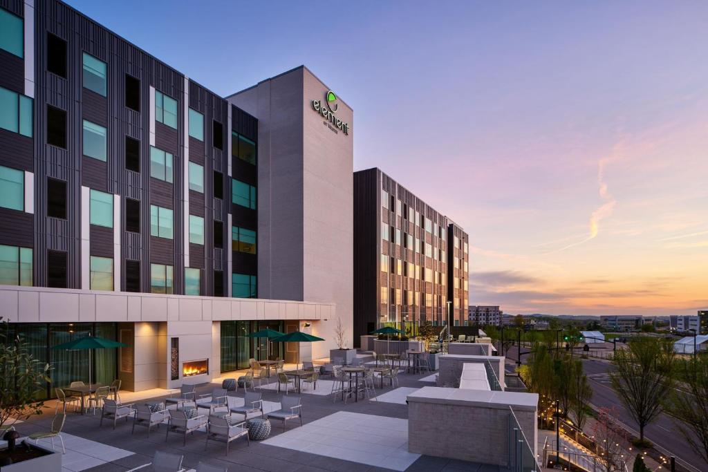 an exterior view of a hotel with tables and chairs at Element Nashville Vanderbilt West End in Nashville