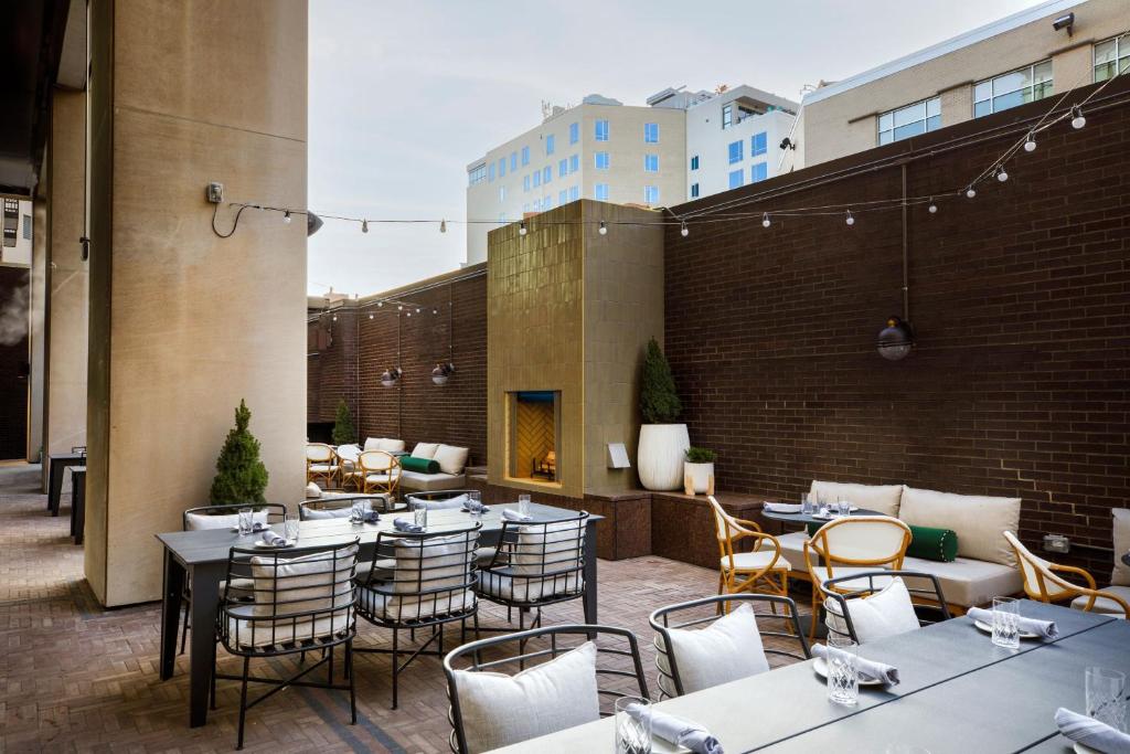 a restaurant with tables and chairs on a patio at Hotel Indy, Indianapolis, a Tribute Portfolio Hotel in Indianapolis