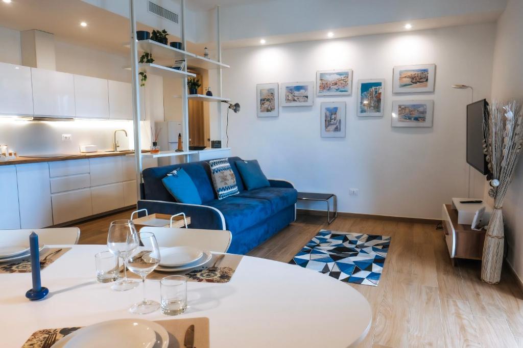 sala de estar con sofá azul y mesa en JLH Aparts - Just Like Home, en Bari