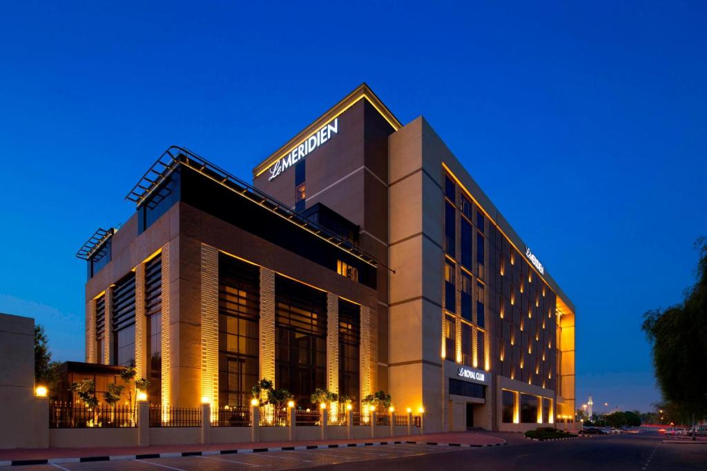 a building with a sign on the side of it at Le Meridien Dubai Hotel, Royal Club & Conference Centre in Dubai